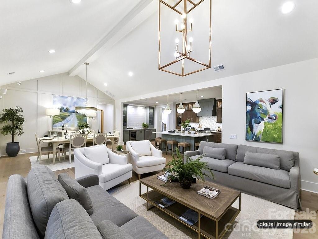 1002 Kingbird Lane, Unit 7 Clover, SC 29710 - Photo 8 of 40 a living room with furniture kitchen view and a chandelier