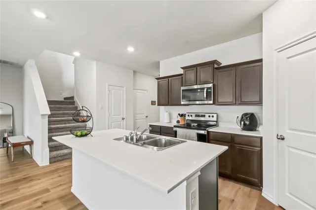 a kitchen that has a sink and a stove in it