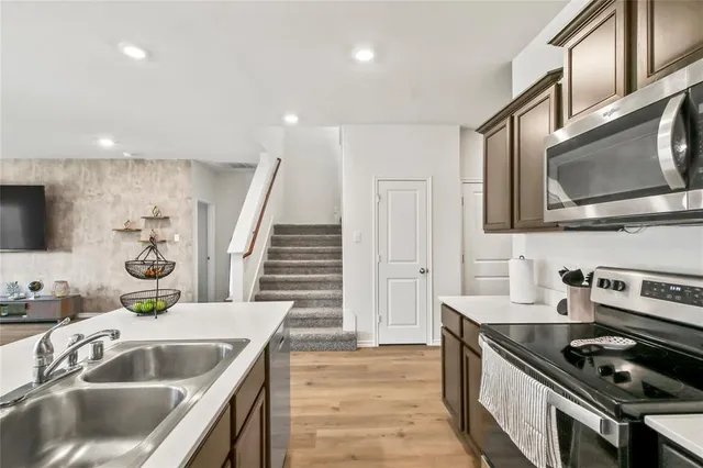 a kitchen with stainless steel appliances granite countertop a sink and stove