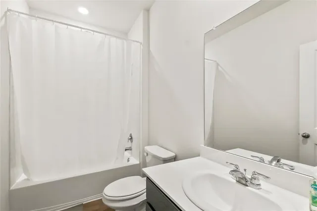 a bathroom with a sink toilet and a mirror