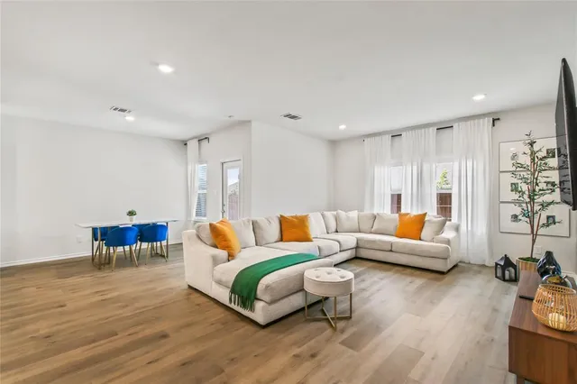 a living room with furniture and wooden floor