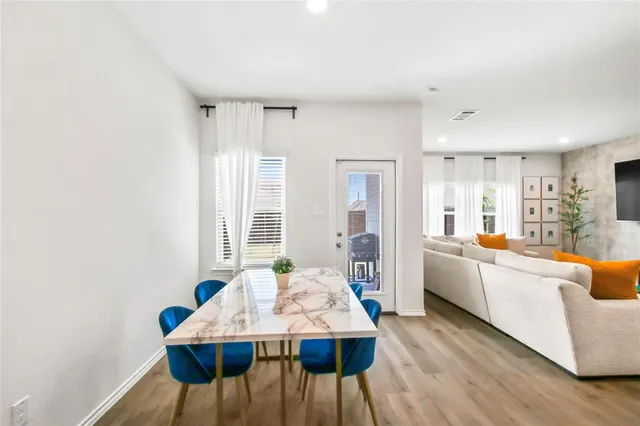 a large white kitchen with a dining table and chairs