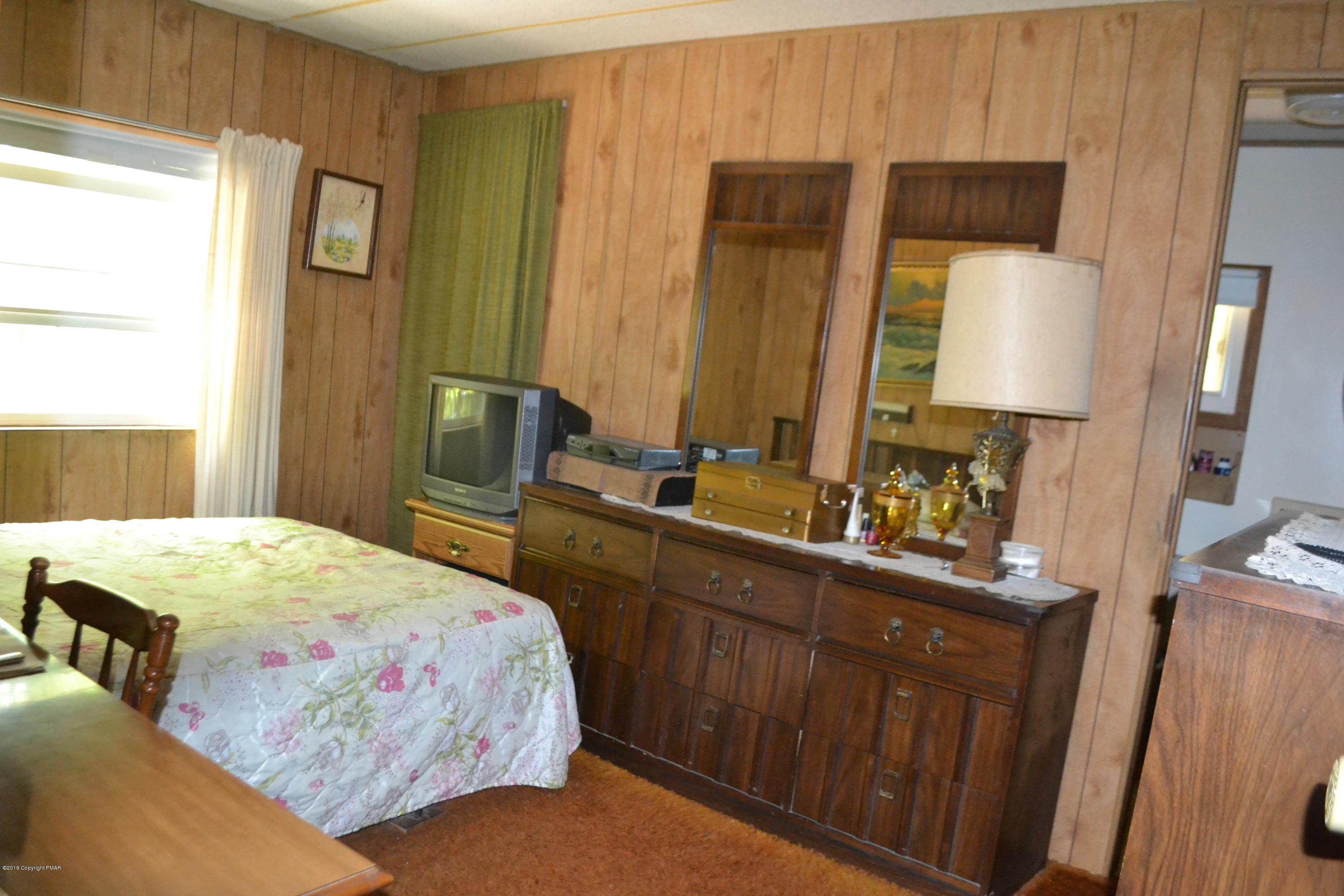 130 Stadden Road Stroudsburg, PA 18360 - Photo 15 of 24 a bedroom with a bed a mirror and dresser