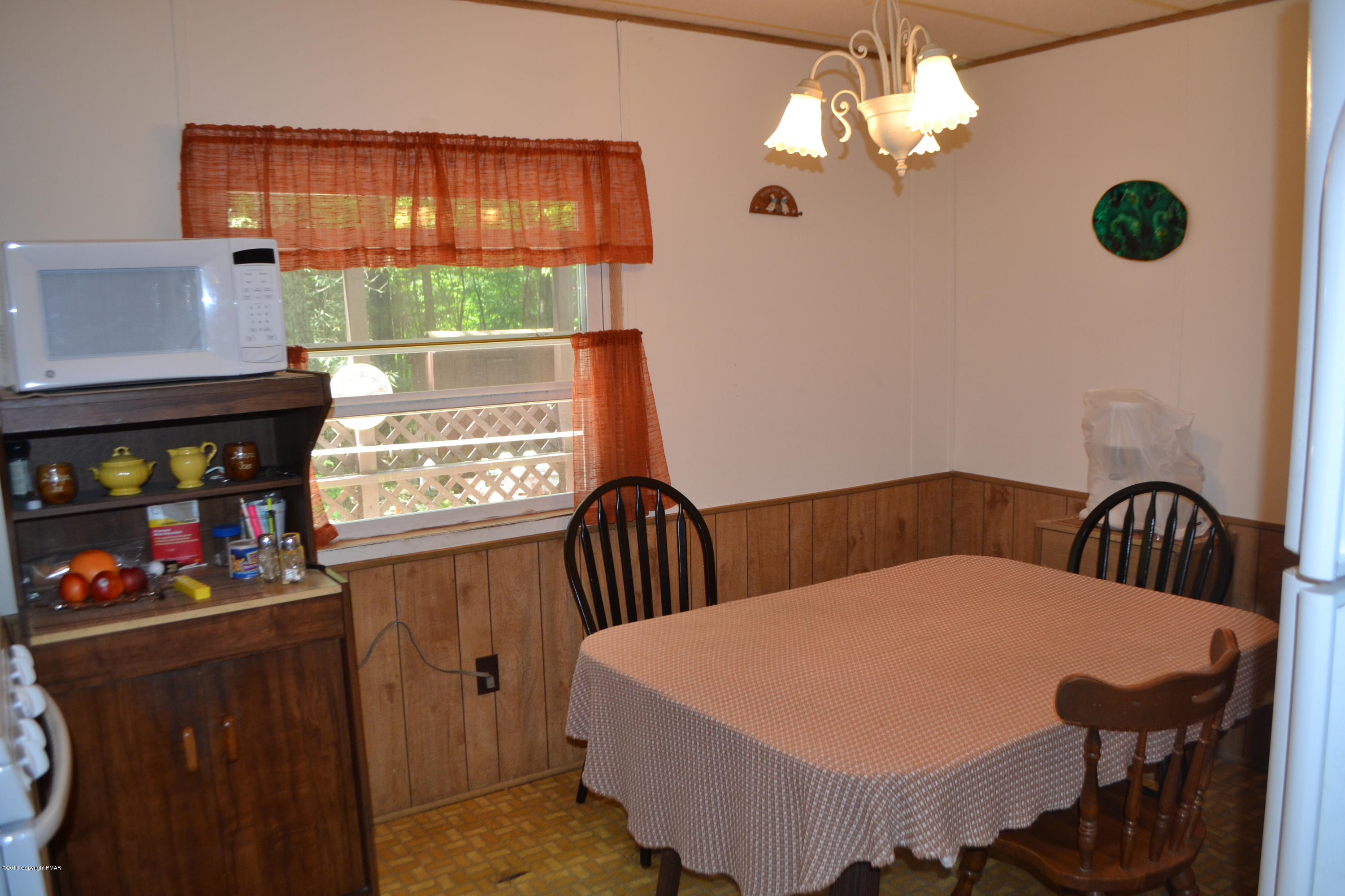 130 Stadden Road Stroudsburg, PA 18360 - Photo 19 of 24 a dining room with furniture a chandelier and a window