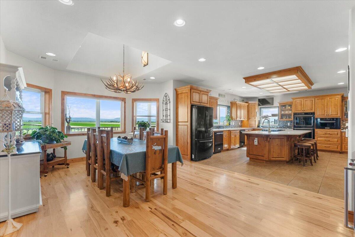 41494 Gomez Road Fall River Mills, CA 96028 - Photo 14 of 92 a view of a dining room with furniture window and wooden floor
