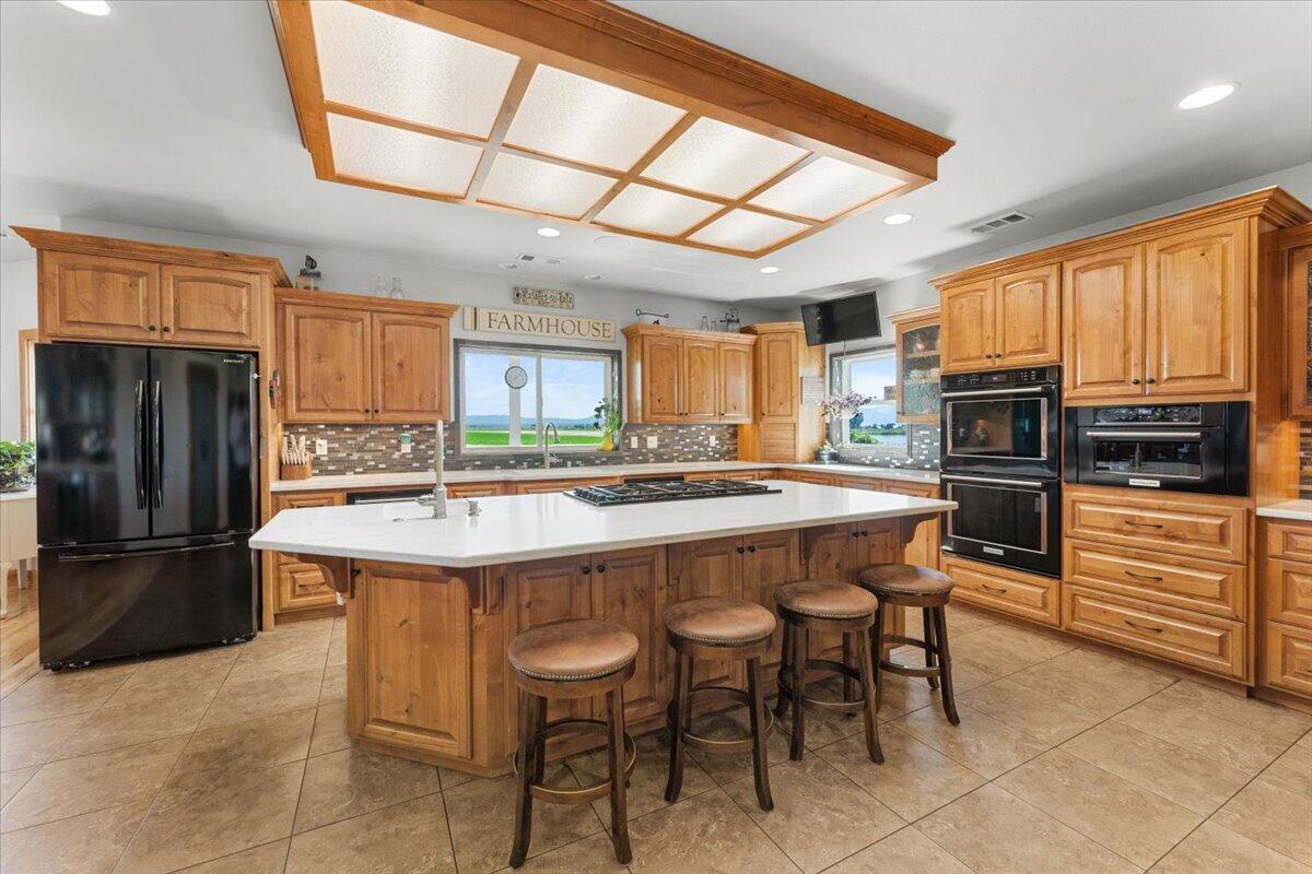 41494 Gomez Road Fall River Mills, CA 96028 - Photo 20 of 92 a kitchen with stainless steel appliances granite countertop a refrigerator and a stove top oven