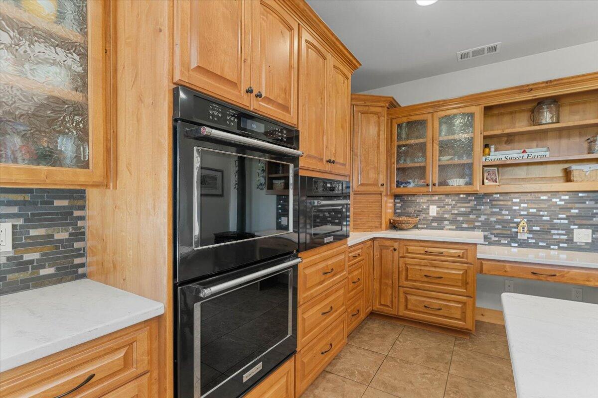 41494 Gomez Road Fall River Mills, CA 96028 - Photo 21 of 92 a kitchen with granite countertop stainless steel appliances and wooden cabinets