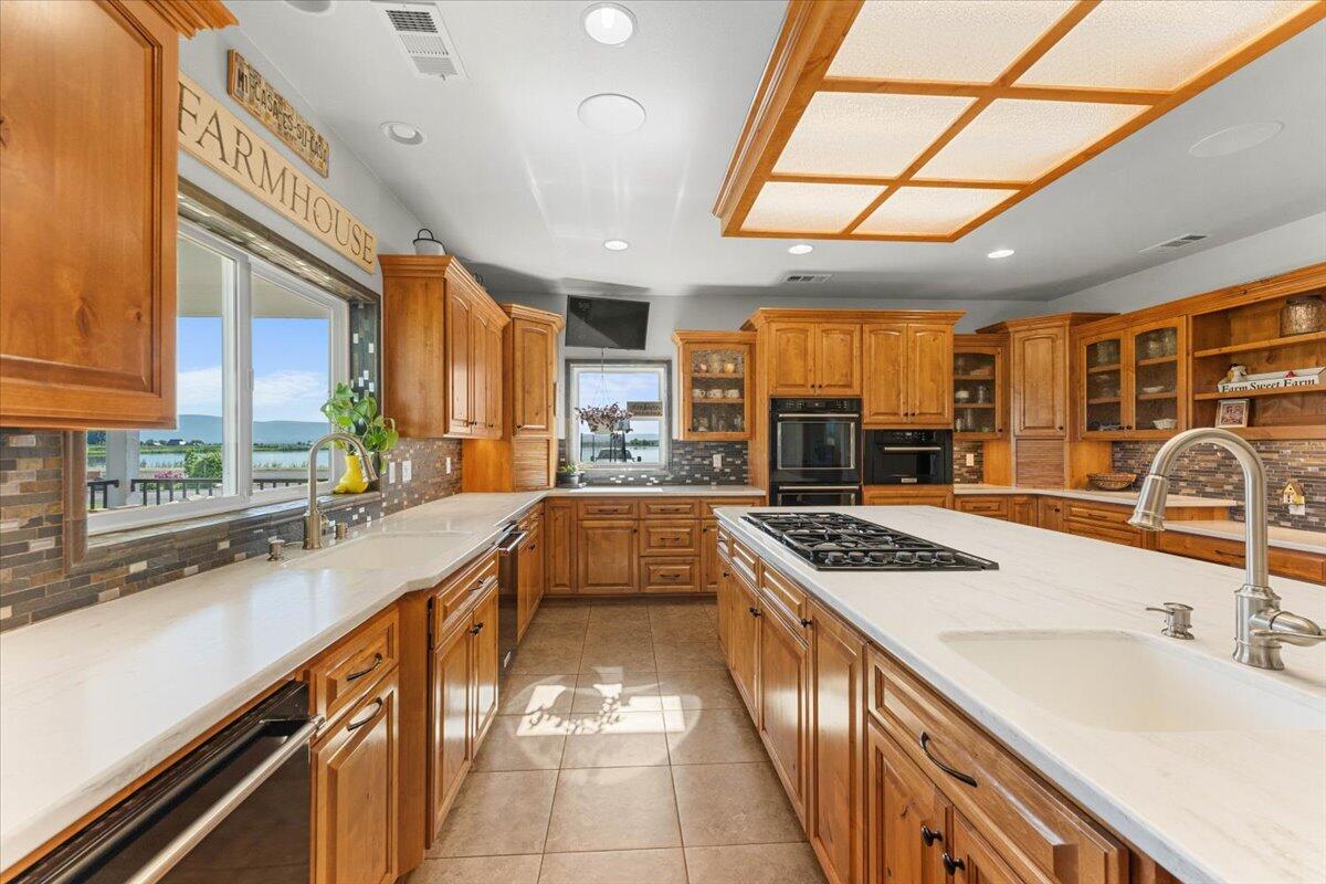 41494 Gomez Road Fall River Mills, CA 96028 - Photo 23 of 92 a kitchen with stainless steel appliances granite countertop a sink stove and cabinets