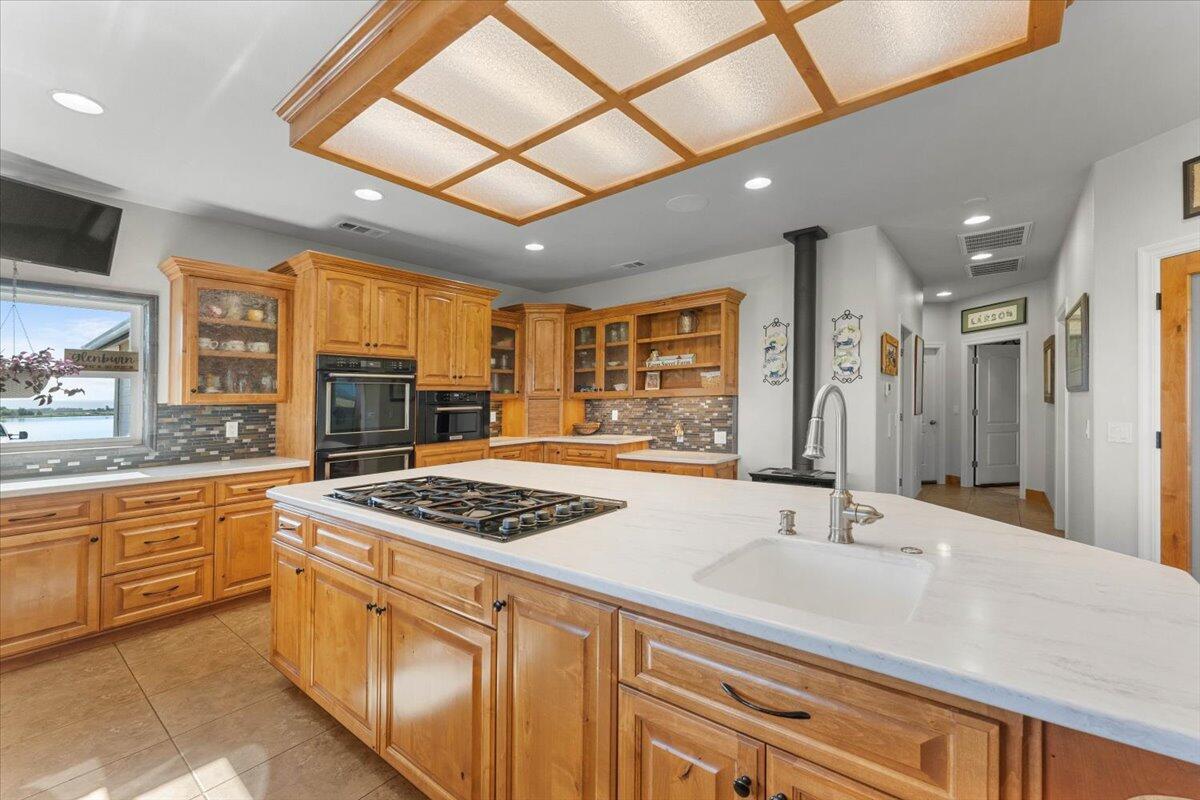 41494 Gomez Road Fall River Mills, CA 96028 - Photo 24 of 92 a kitchen with stainless steel appliances granite countertop a sink stove and cabinets