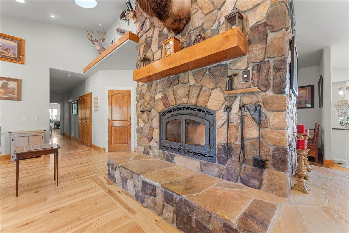 41494 Gomez Road Fall River Mills, CA 96028 - Photo 26 of 92 a living room with fireplace furniture and a wooden floor