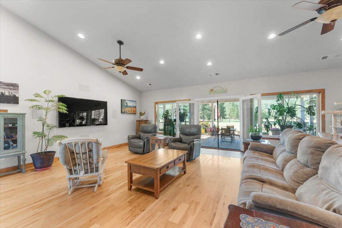 41494 Gomez Road Fall River Mills, CA 96028 - Photo 29 of 92 a living room with furniture a flat screen tv and a large window