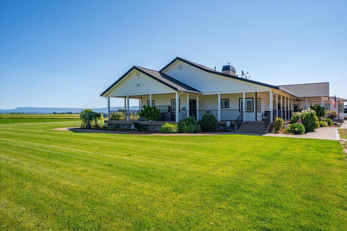 41494 Gomez Road Fall River Mills, CA 96028 - Photo 46 of 92 a front view of a house with a garden and lake view
