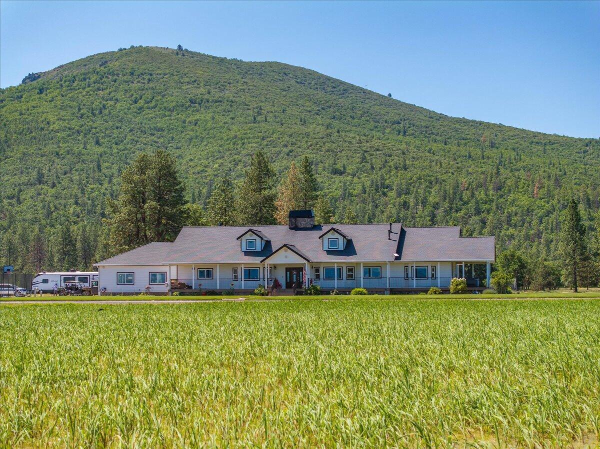 41494 Gomez Road Fall River Mills, CA 96028 - Photo 50 of 92 a view of a house with a big yard and large trees