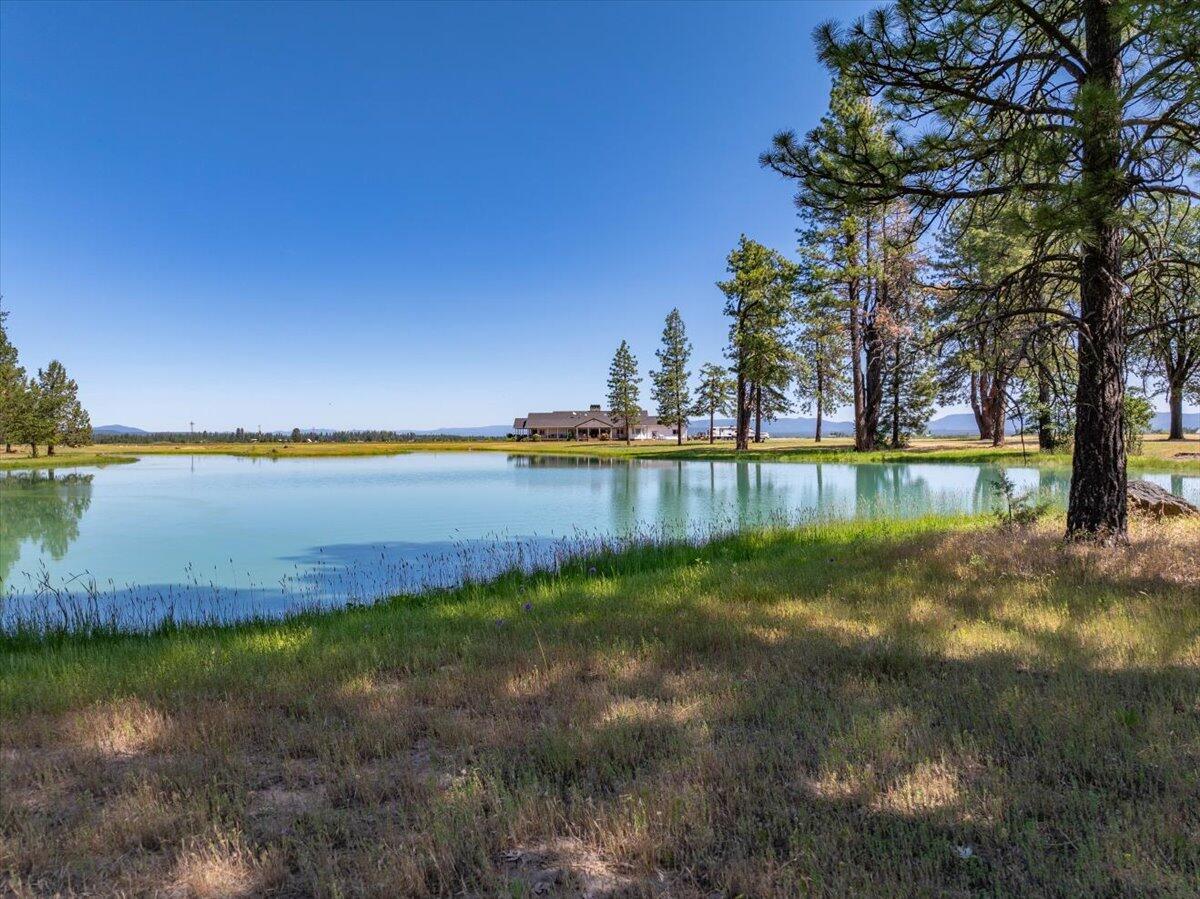41494 Gomez Road Fall River Mills, CA 96028 - Photo 54 of 92 a view of a lake with houses in the back