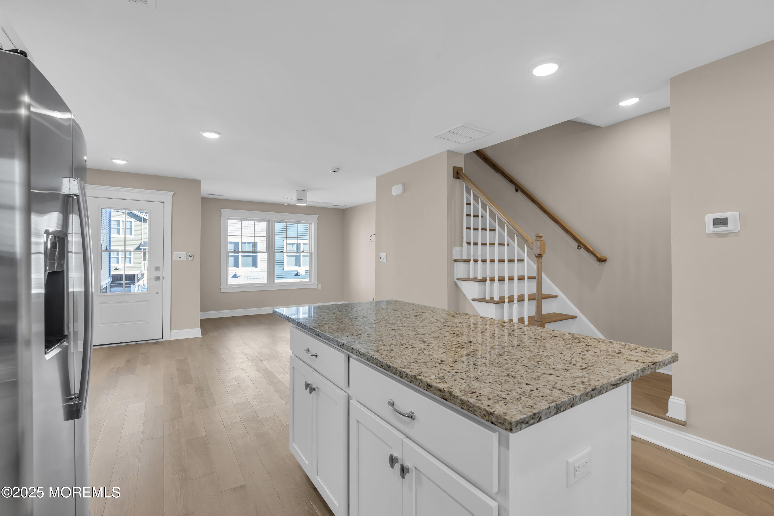 24 Shell Road, Unit 126 Mantoloking, NJ 08738 - Photo 12 of 31 a view of kitchen and hall with wooden floor and windows