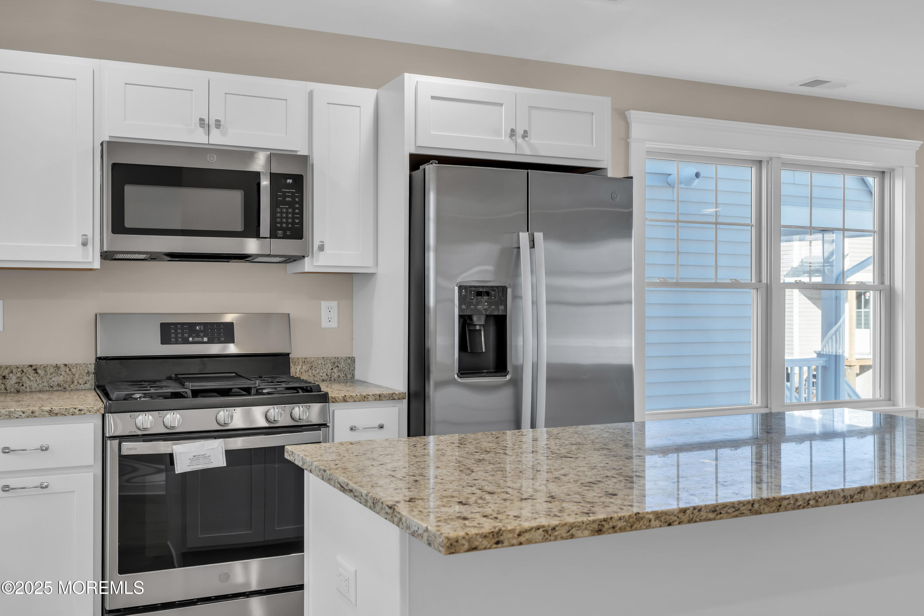 24 Shell Road, Unit 126 Mantoloking, NJ 08738 - Photo 13 of 31 a kitchen with stainless steel appliances granite countertop a stove microwave and sink
