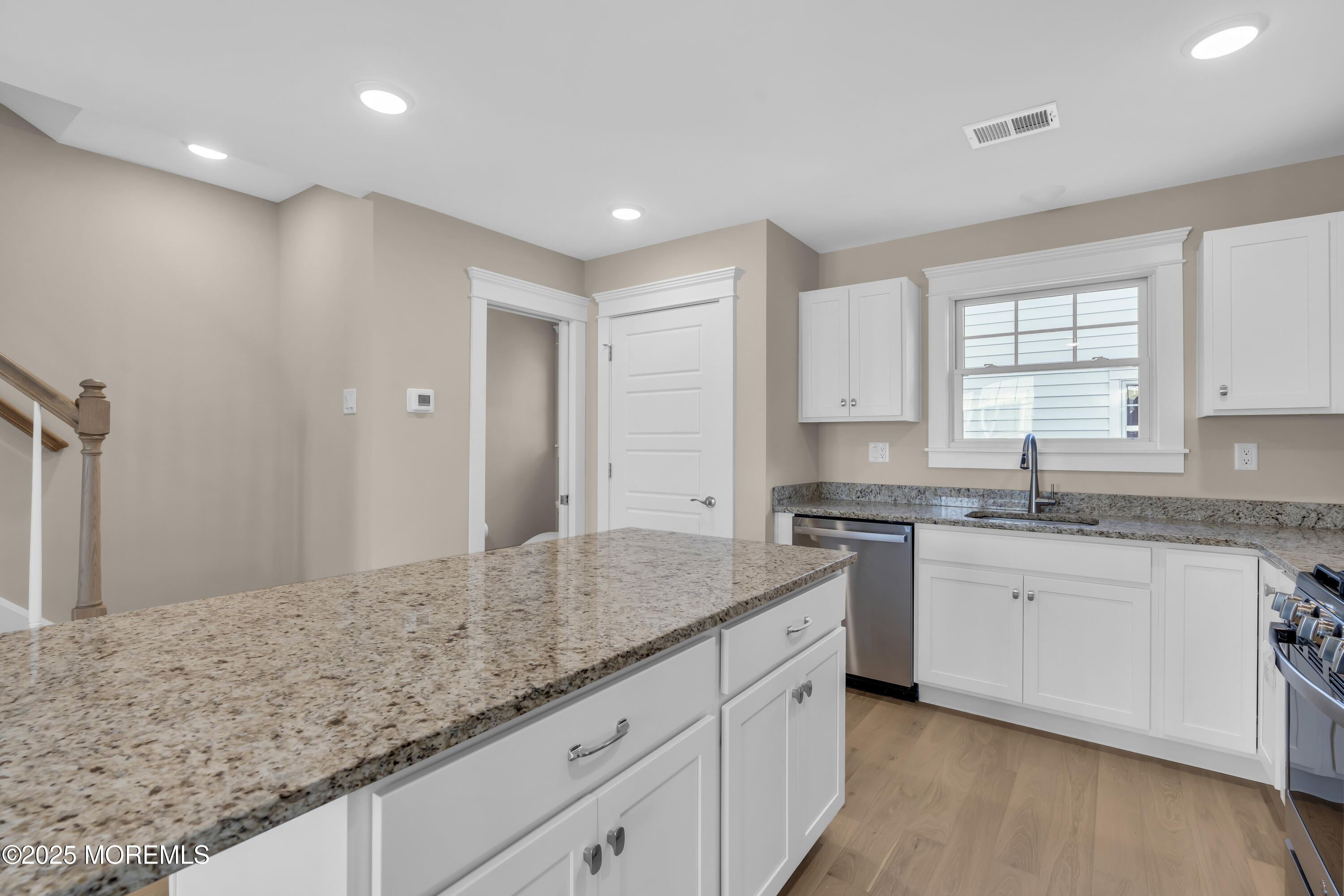 24 Shell Road, Unit 126 Mantoloking, NJ 08738 - Photo 15 of 31 a kitchen with granite countertop sink and cabinets