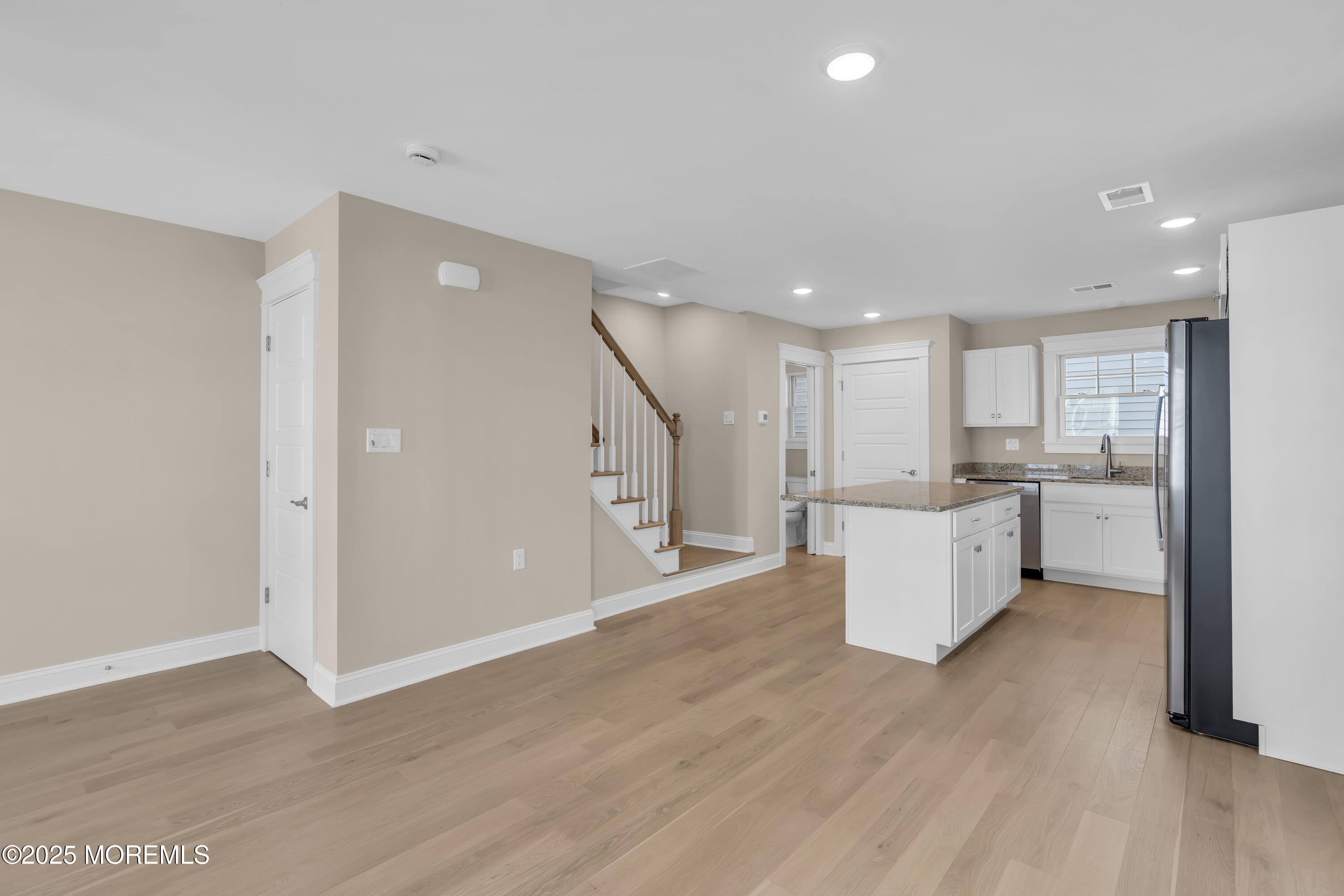 24 Shell Road, Unit 126 Mantoloking, NJ 08738 - Photo 18 of 31 a large kitchen with white cabinets and wooden floor