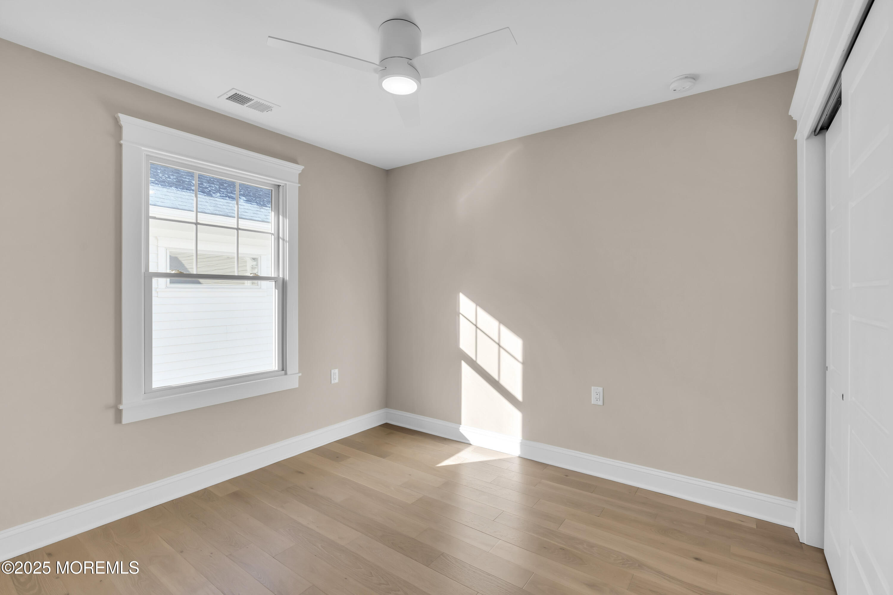 24 Shell Road, Unit 126 Mantoloking, NJ 08738 - Photo 27 of 31 a view of an empty room with wooden floor and a window
