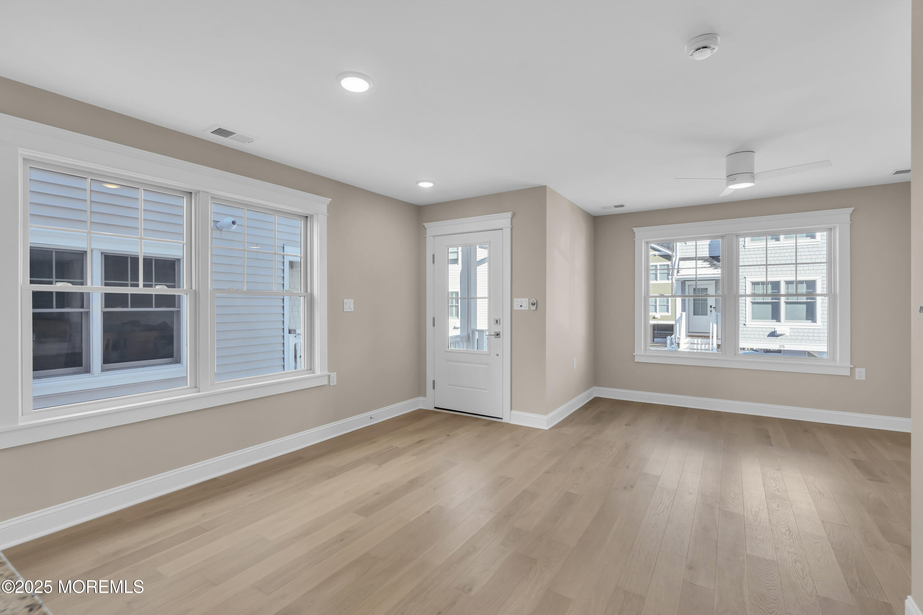24 Shell Road, Unit 126 Mantoloking, NJ 08738 - Photo 8 of 31 a view of an empty room with a window and wooden floor