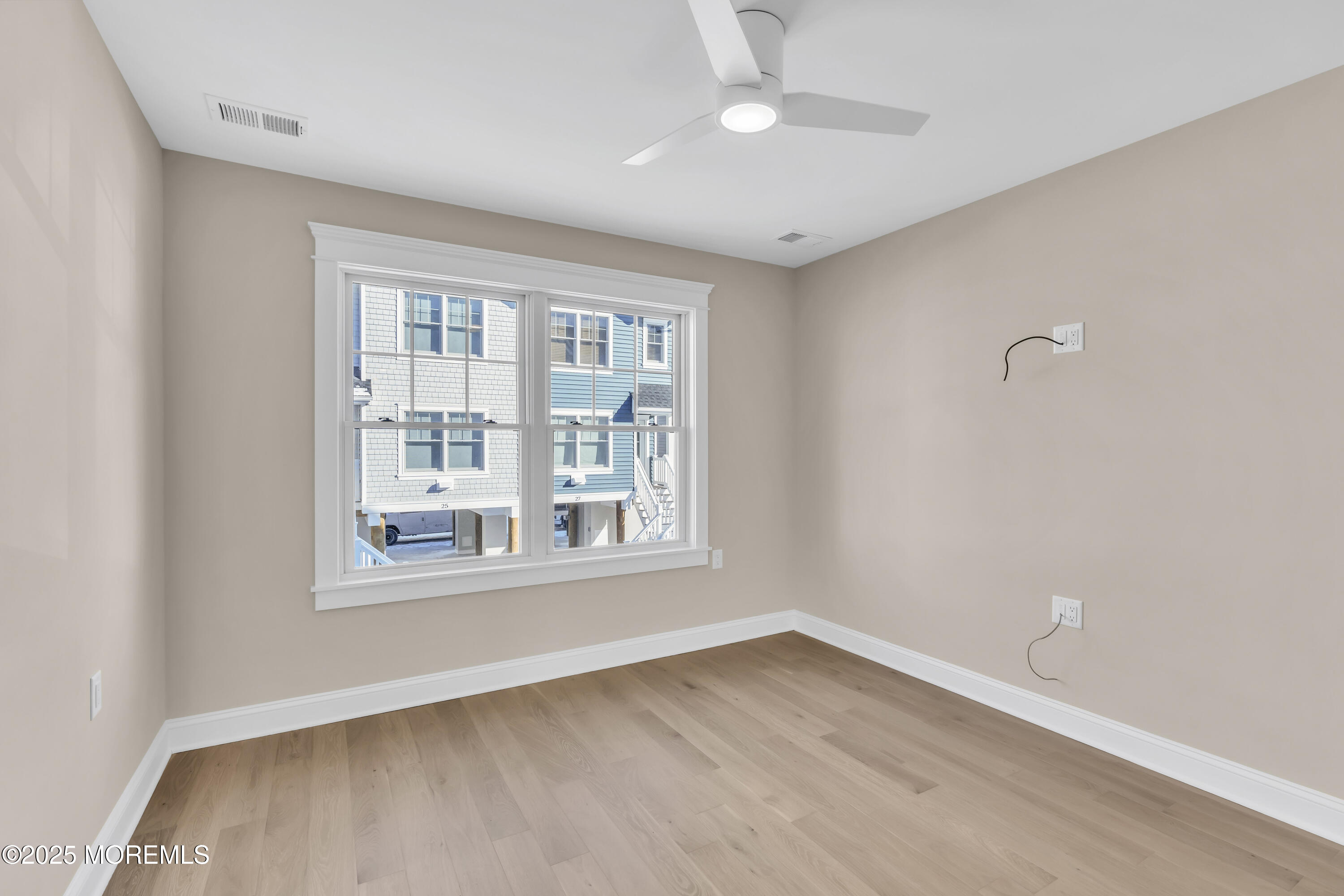 24 Shell Road, Unit 126 Mantoloking, NJ 08738 - Photo 9 of 31 an empty room with wooden floor and windows
