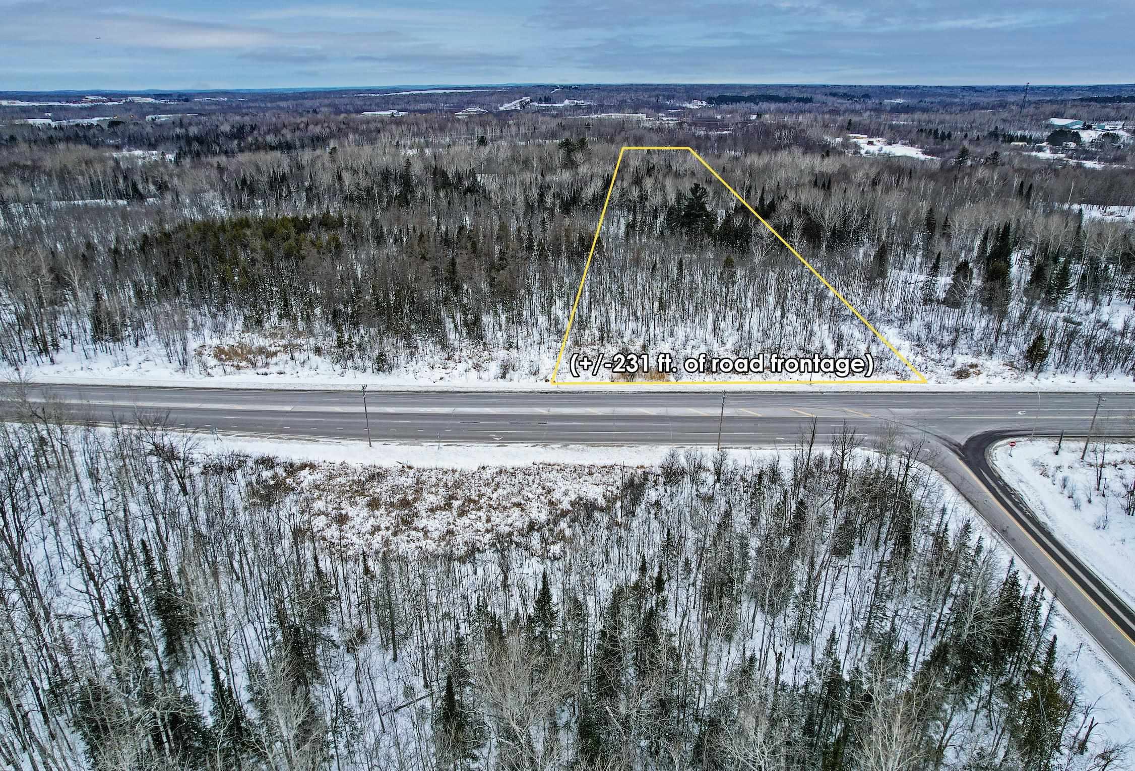 Snowy aerial view with a forest view