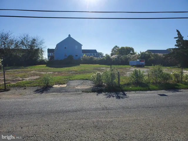 a view of a street with a building in the background