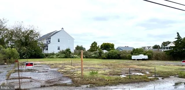 a view of a white house with a yard