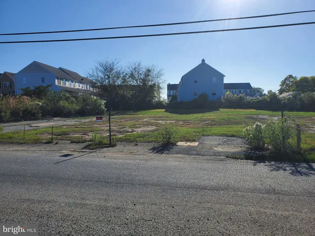 a view of a house with a yard and a street