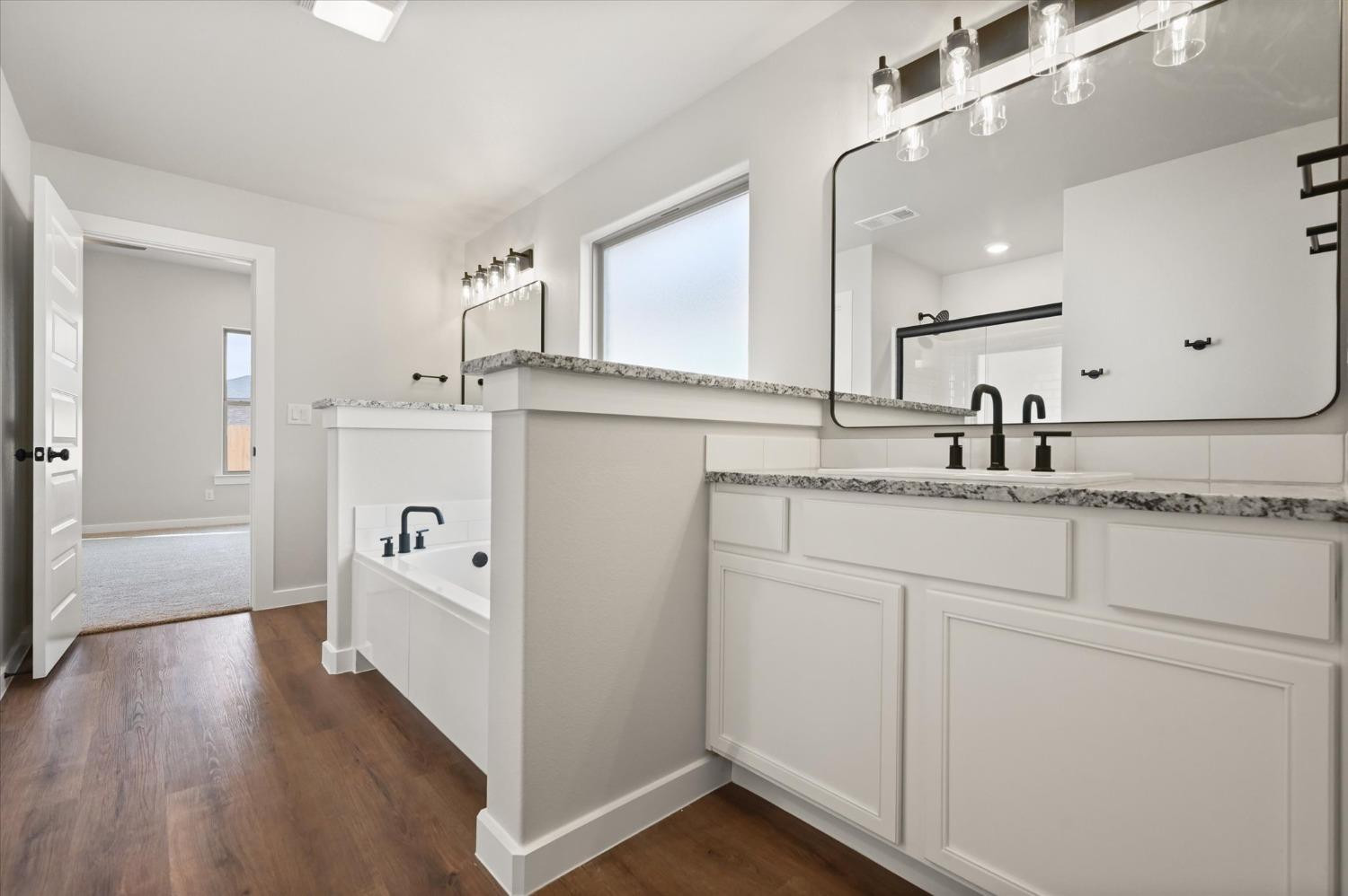 13604 Wheeler Avenue Lubbock, TX 79423 - Photo 17 of 23 a kitchen with kitchen island white cabinets and refrigerator