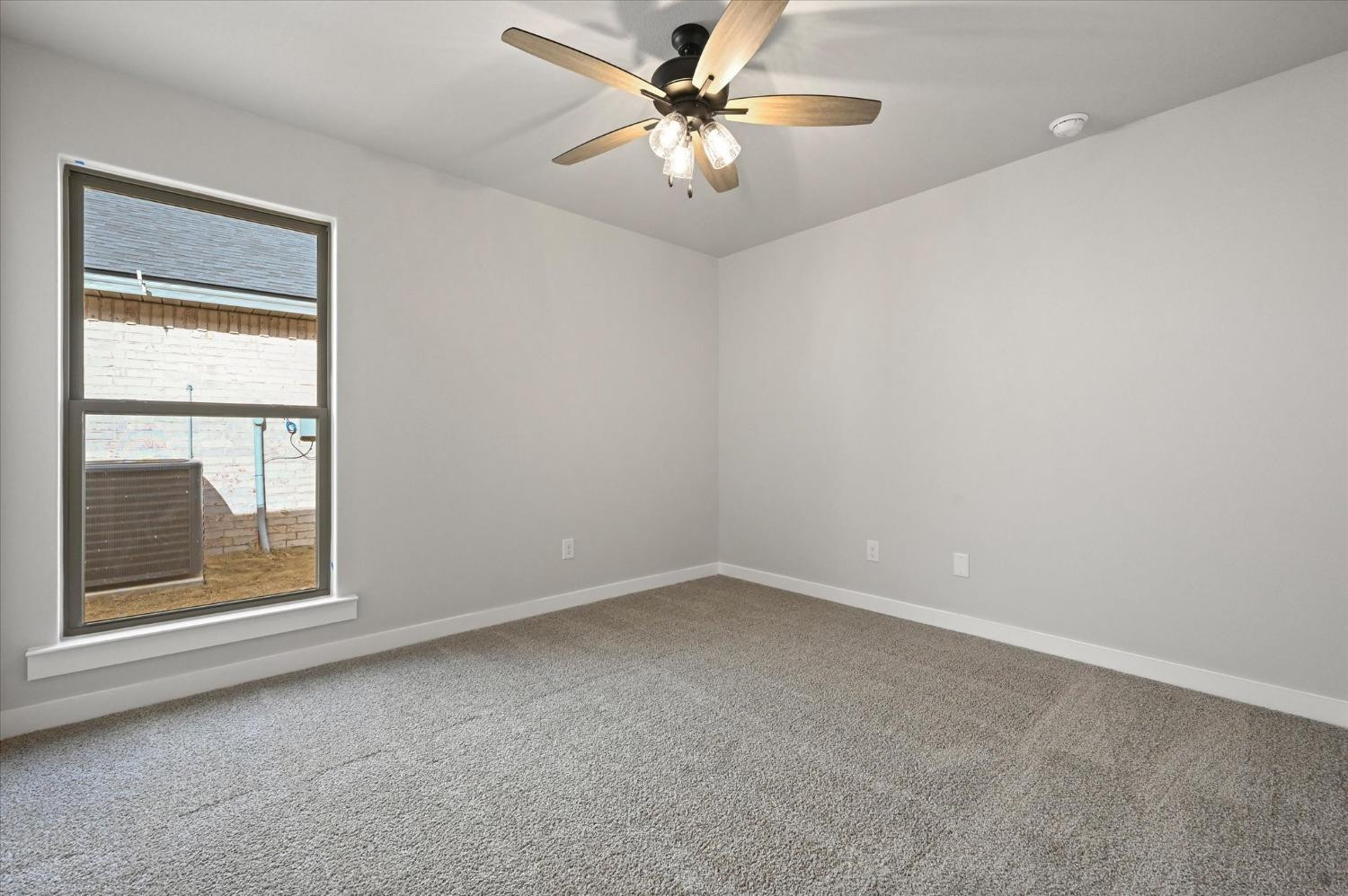 13604 Wheeler Avenue Lubbock, TX 79423 - Photo 19 of 23 an empty room with a window and a fan