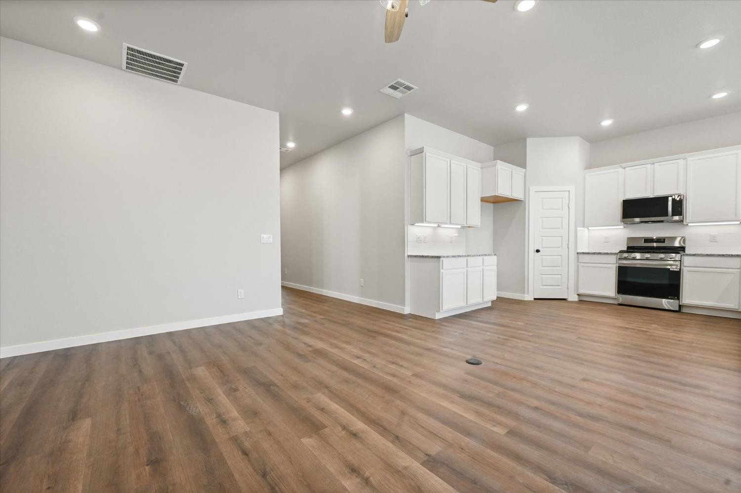 13604 Wheeler Avenue Lubbock, TX 79423 - Photo 6 of 23 a view of kitchen with wooden floor and electronic appliances
