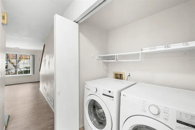 a view of washer and dryer with kitchen in the background