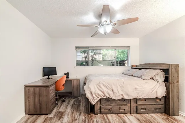 a bedroom with a bed and wooden floor