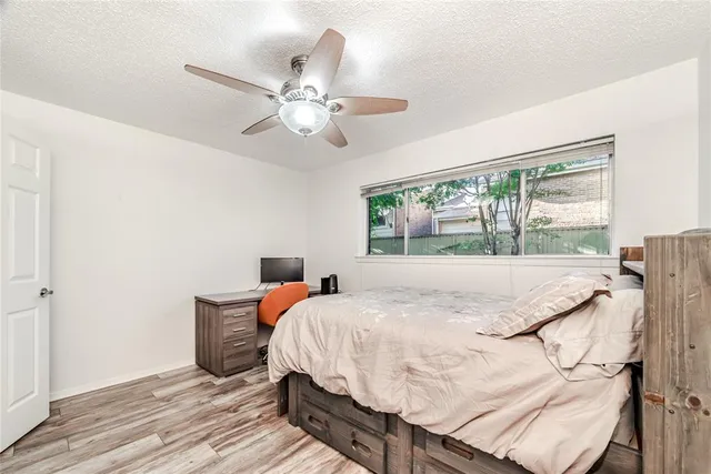 a bed sitting in a bedroom next to a window