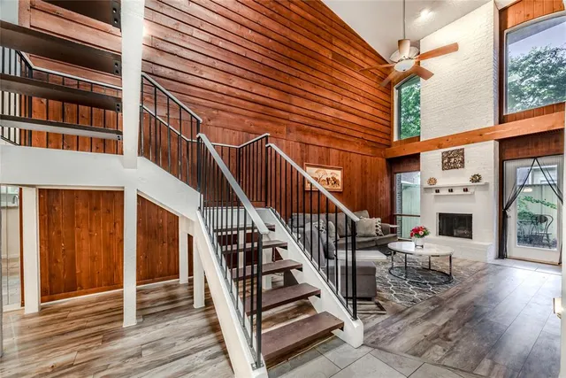 a view of a balcony with chairs and wooden floor