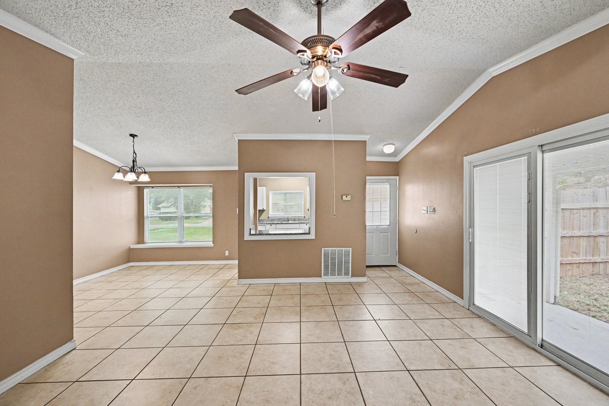 8406 Forest Ridge Drive San Antonio, TX 78239 - Photo 8 of 33 a view of an empty room with window and chandelier fan