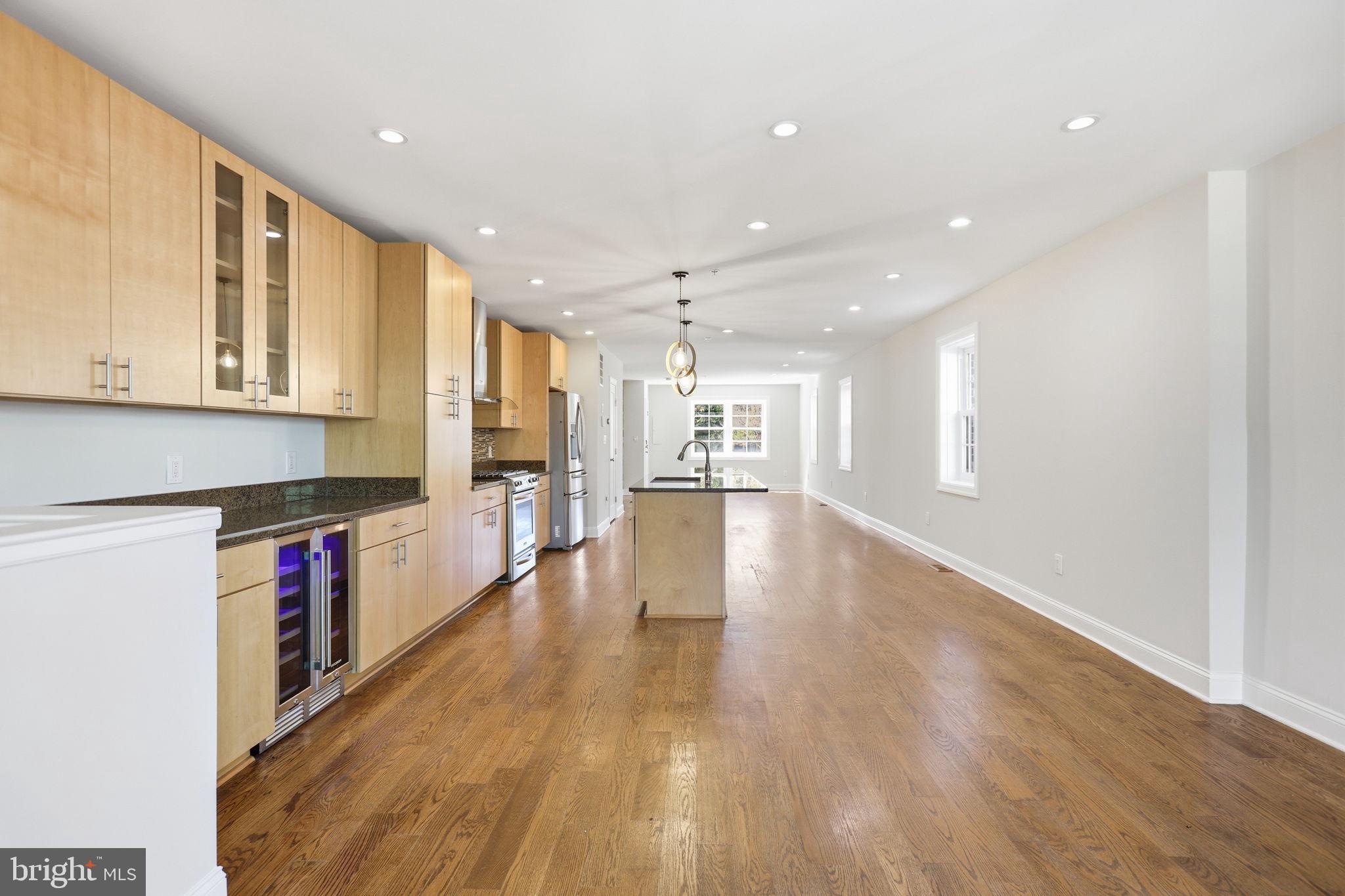 1820 Independence Avenue Southeast, Unit 1 Washington, DC 20003 - Photo 11 of 32 a view of a kitchen with kitchen island wooden floors appliances