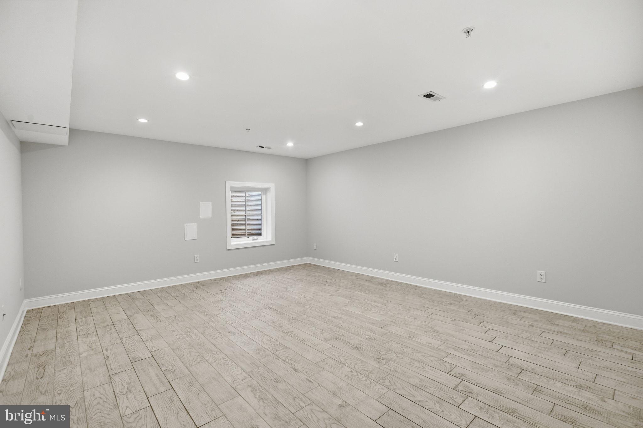 1820 Independence Avenue Southeast, Unit 1 Washington, DC 20003 - Photo 18 of 32 an empty room with wooden floor and windows