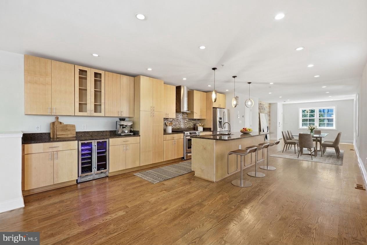 1820 Independence Avenue Southeast, Unit 1 Washington, DC 20003 - Photo 2 of 32 a large white kitchen with lots of counter top space and stainless steel appliances