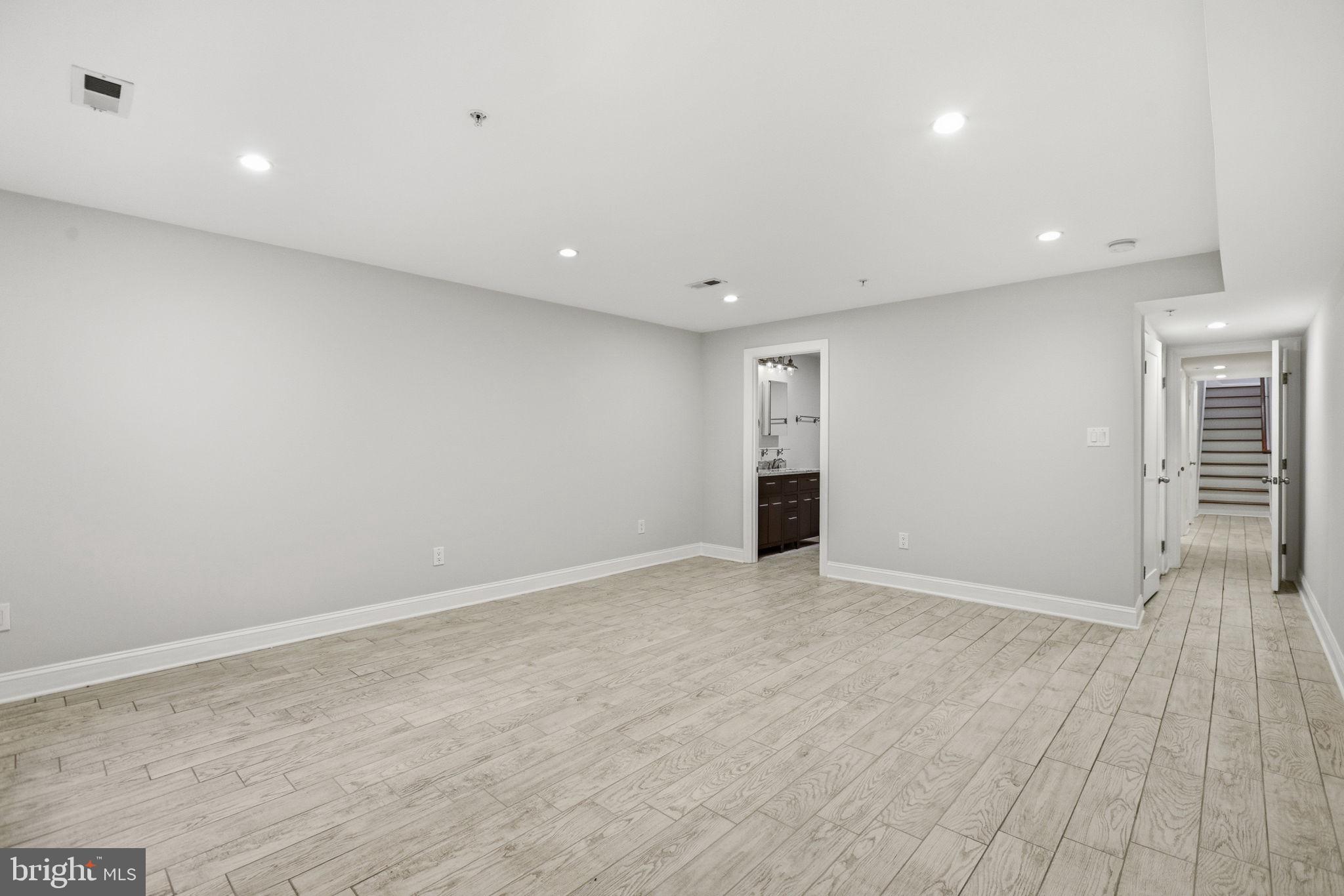 1820 Independence Avenue Southeast, Unit 1 Washington, DC 20003 - Photo 23 of 32 an empty room with wooden floor and windows