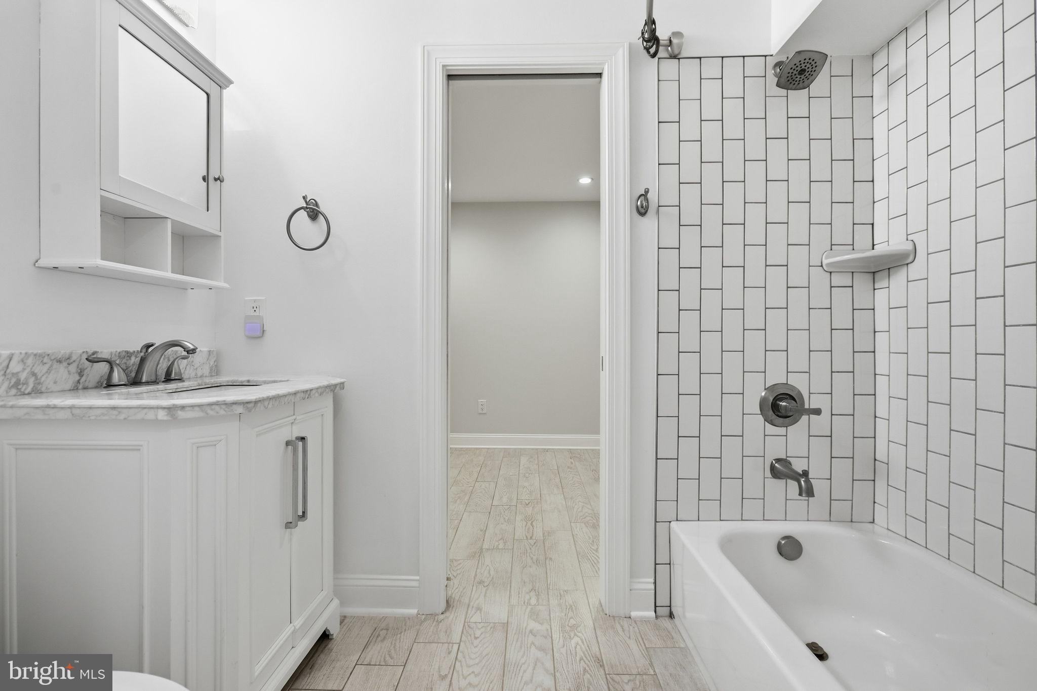 1820 Independence Avenue Southeast, Unit 1 Washington, DC 20003 - Photo 25 of 32 a bathroom with a bathtub and a sink