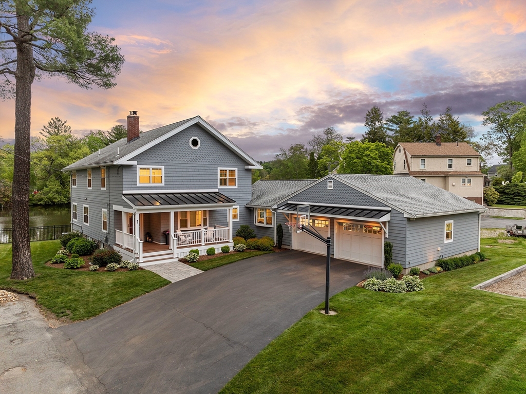 an aerial view of a house with a yard table and chairs