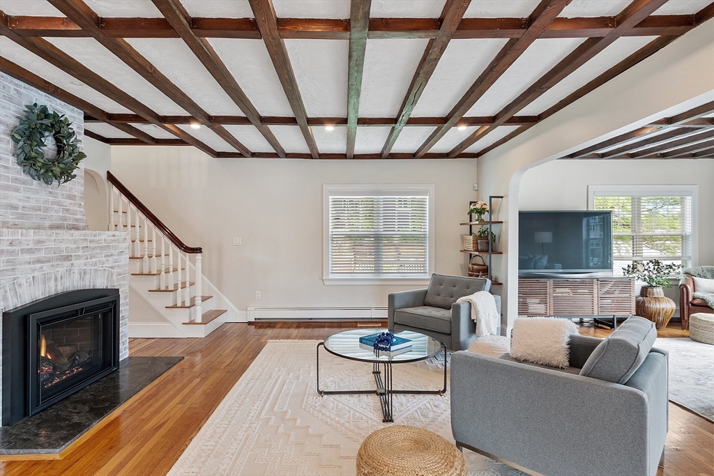 1 Colonial Road Lynnfield, MA 01940 - Photo 18 of 42 a living room with furniture a fireplace and a flat screen tv