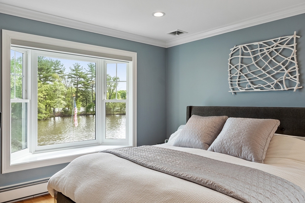 1 Colonial Road Lynnfield, MA 01940 - Photo 22 of 42 a bed sitting in a bedroom next to a window