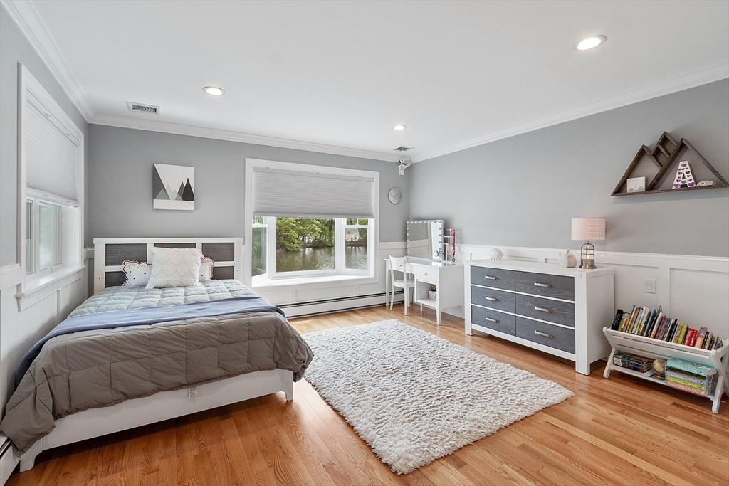 1 Colonial Road Lynnfield, MA 01940 - Photo 23 of 42 a bedroom with a bed and a wooden floor