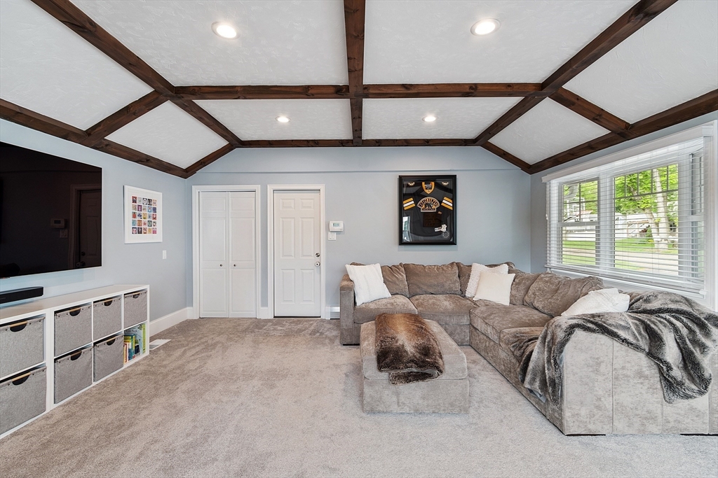 1 Colonial Road Lynnfield, MA 01940 - Photo 28 of 42 a living room with furniture and a flat screen tv