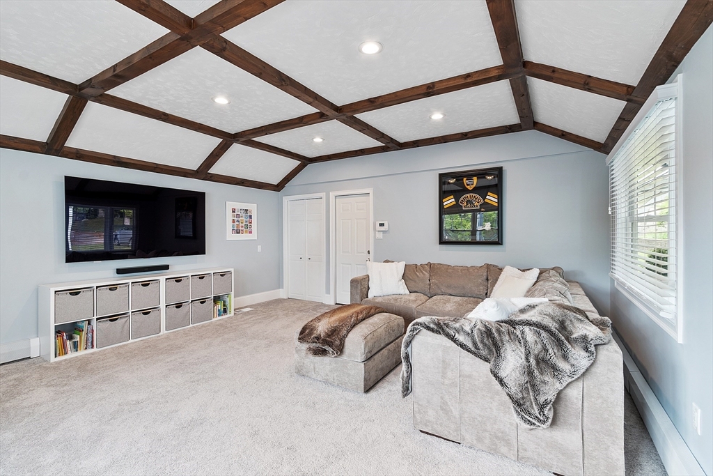 1 Colonial Road Lynnfield, MA 01940 - Photo 29 of 42 a bedroom with furniture and a flat screen tv