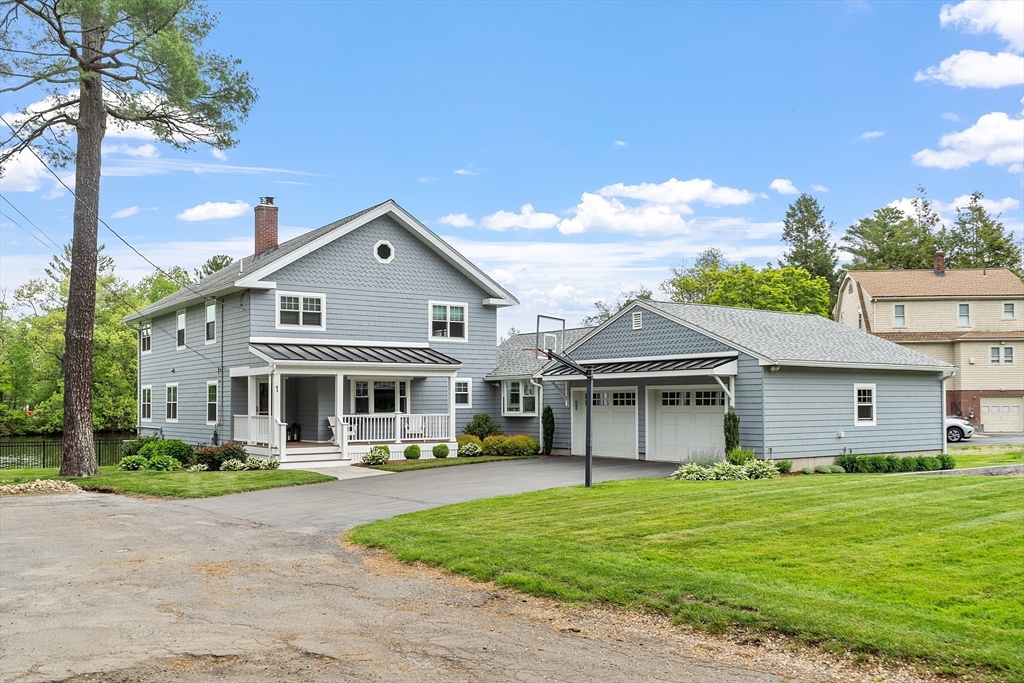 1 Colonial Road Lynnfield, MA 01940 - Photo 30 of 42 a front view of a house with a garden and lake view