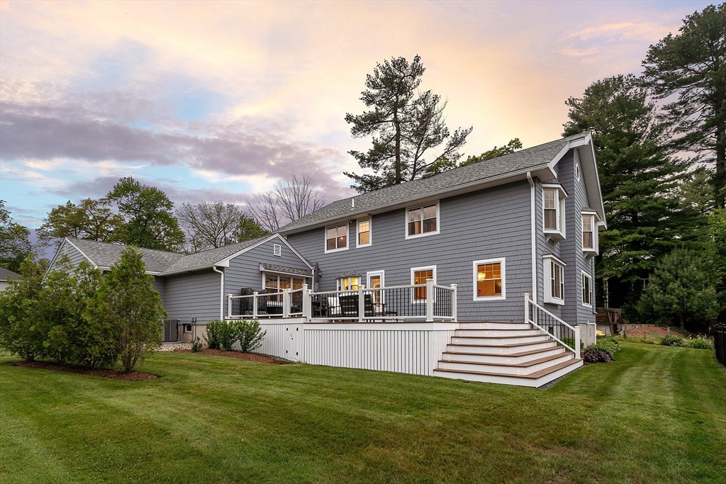 1 Colonial Road Lynnfield, MA 01940 - Photo 3 of 42 a front view of a house with a garden